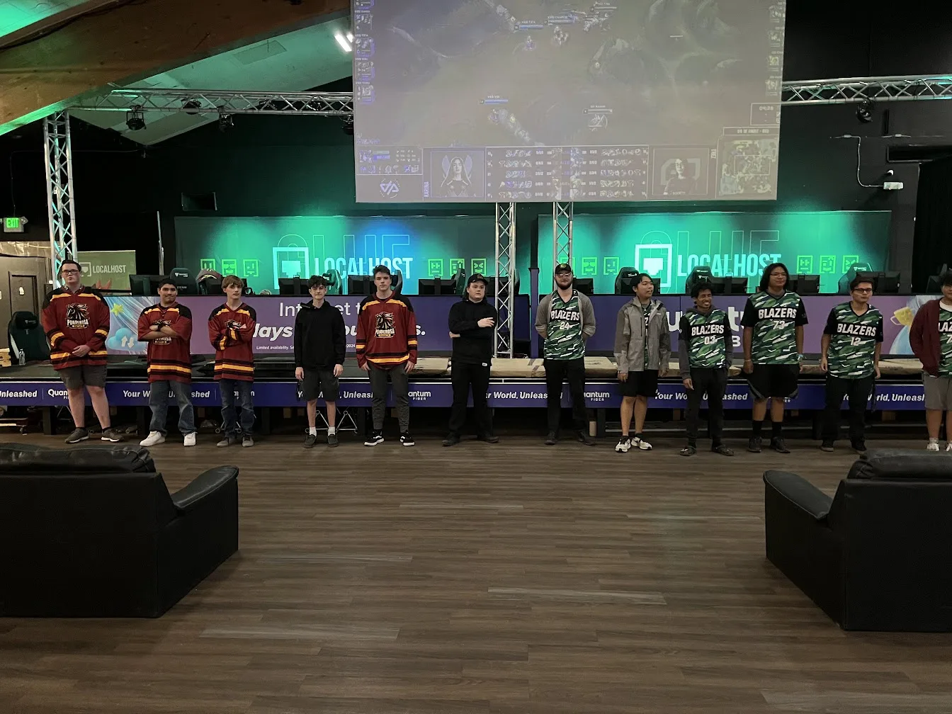 Two esports teams meeting on a live competition stage